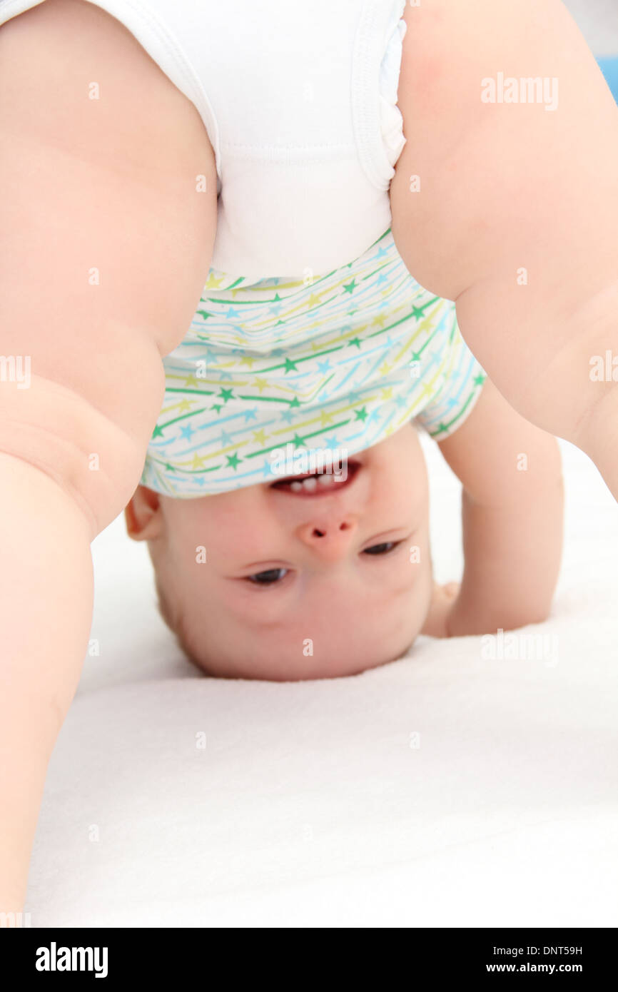 baby standing on head Stock Photo