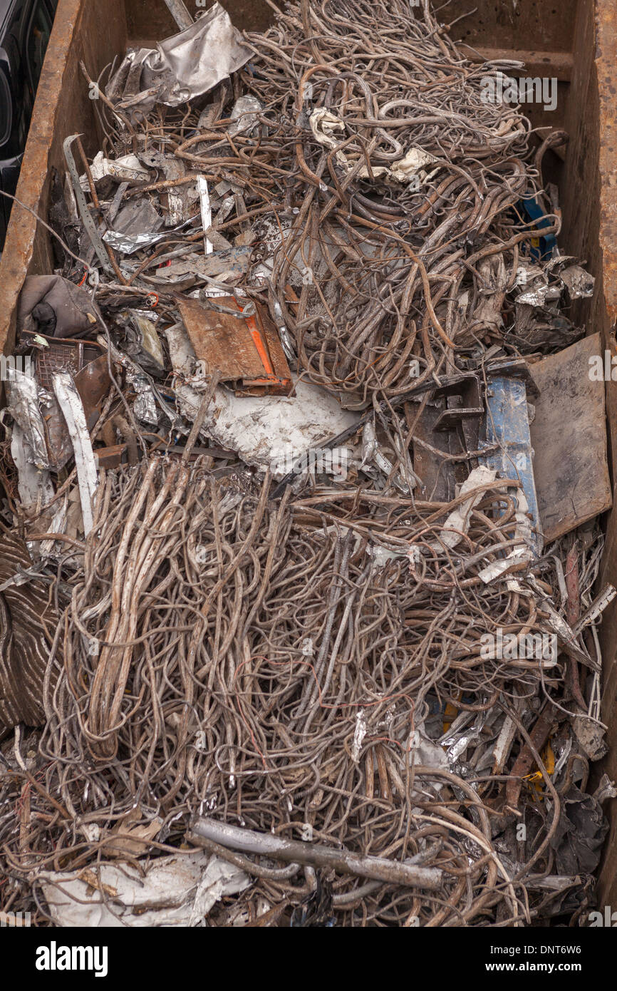 Scrap metal in a recycling container Stock Photo