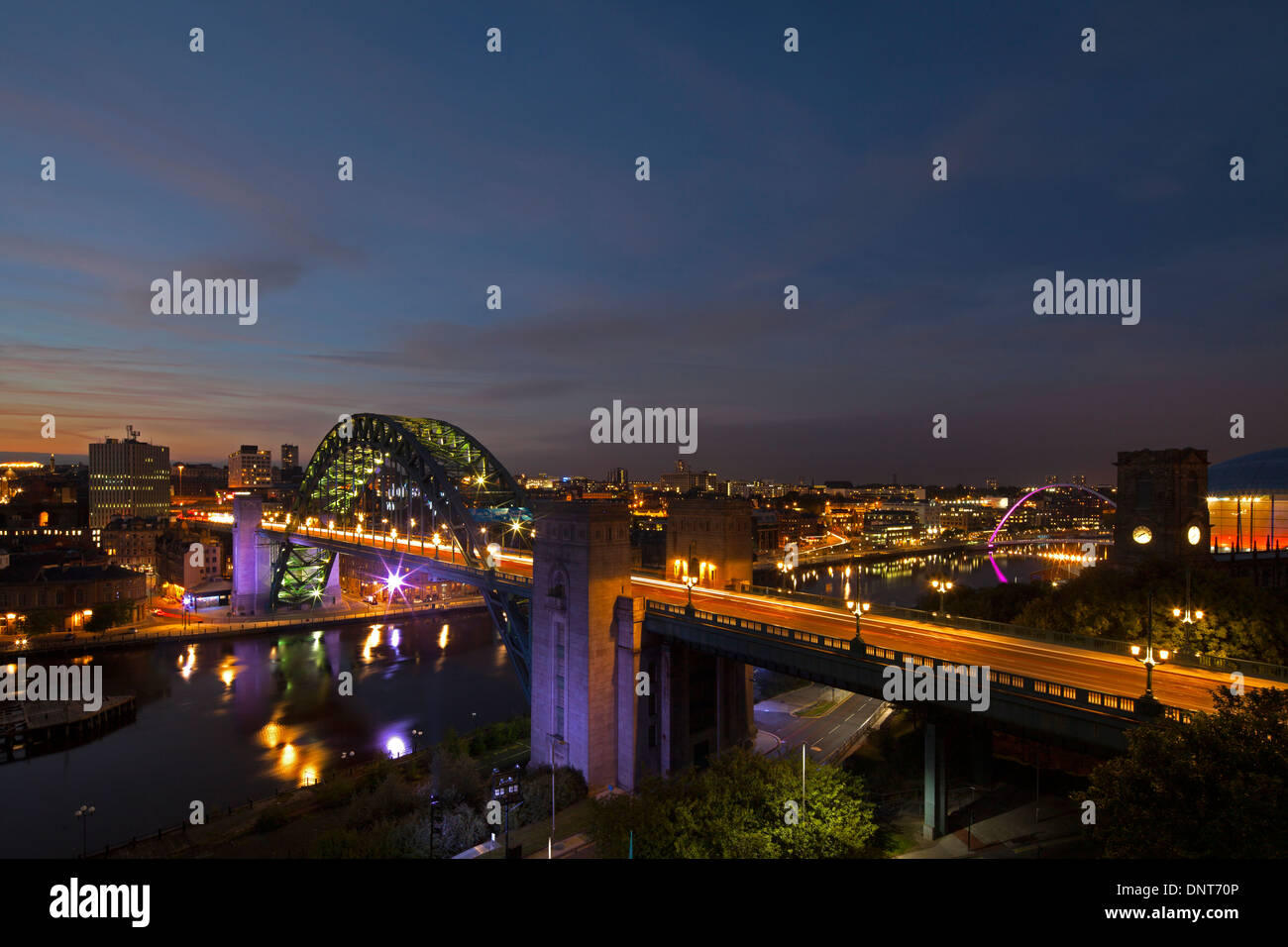 A view of Newcastle quayside and the Tyne Bridge at dusk as seen from Gateshead Stock Photo