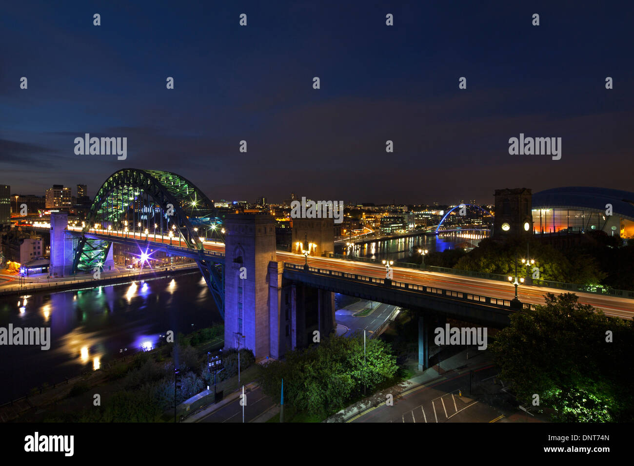 A view of Newcastle quayside and the Tyne Bridge at dusk as seen from Gateshead Stock Photo
