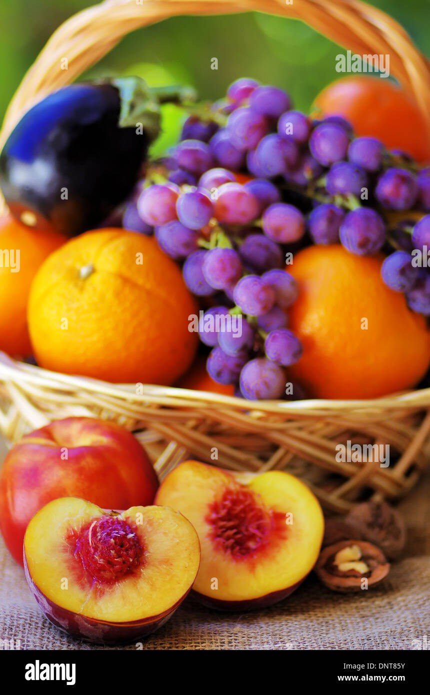 Basket full of citrus fruits and peaches Stock Photo - Alamy