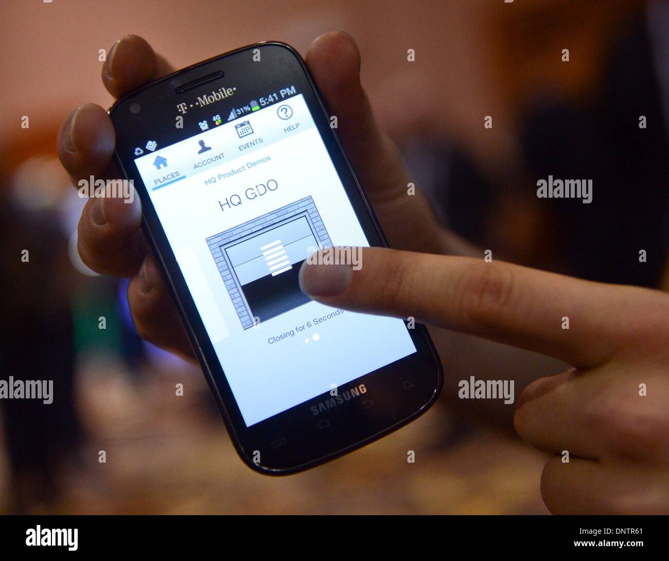 Las Vegas, USA. 05th Jan, 2014. A man opens a garage door with the app ...