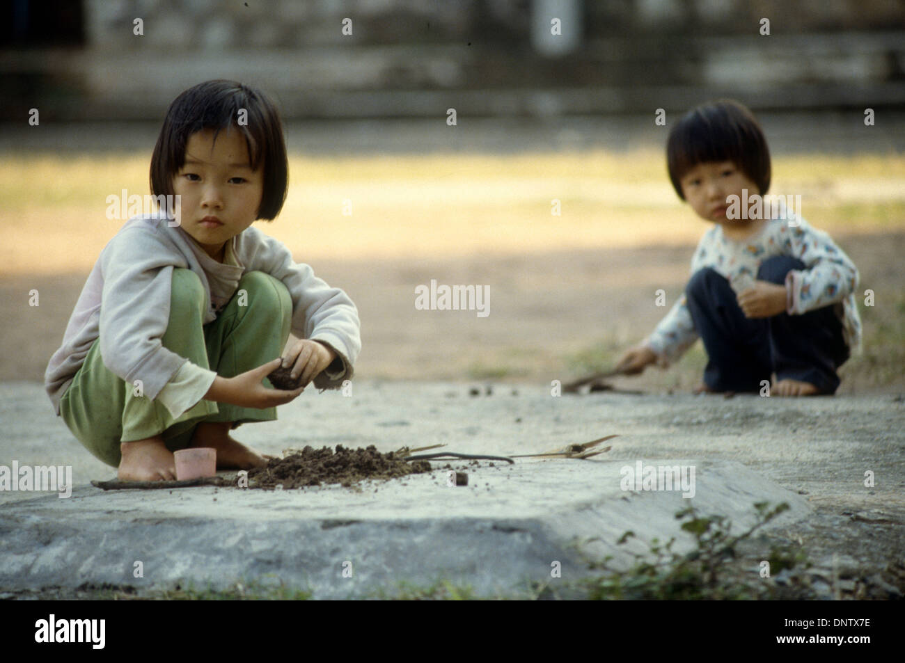 Two little girls playing in a playground in Guangzhou, China Stock Photo