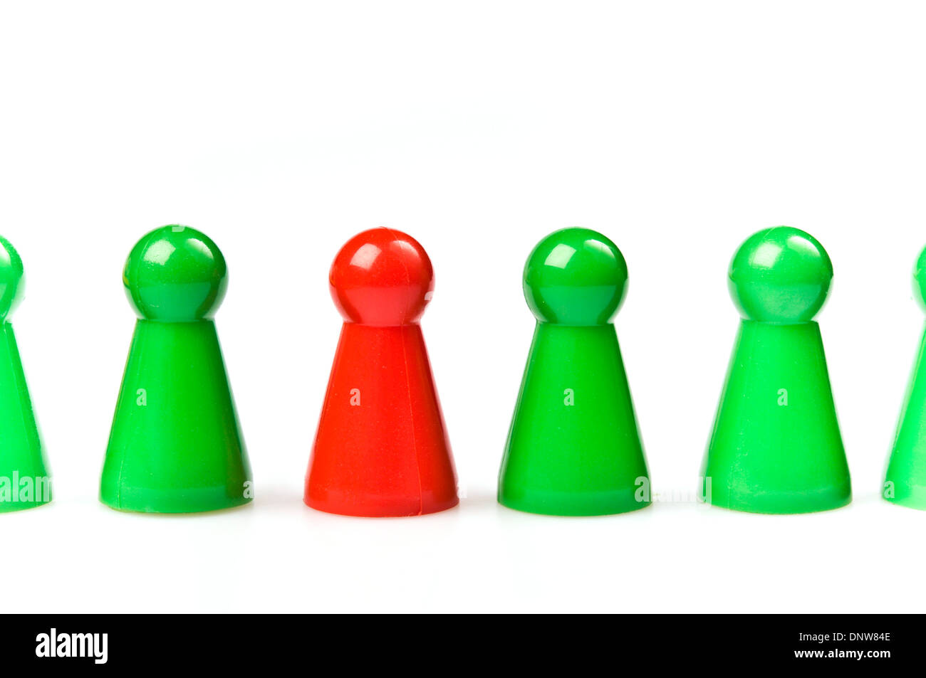green plastic counters with one red, standing out concept Stock Photo