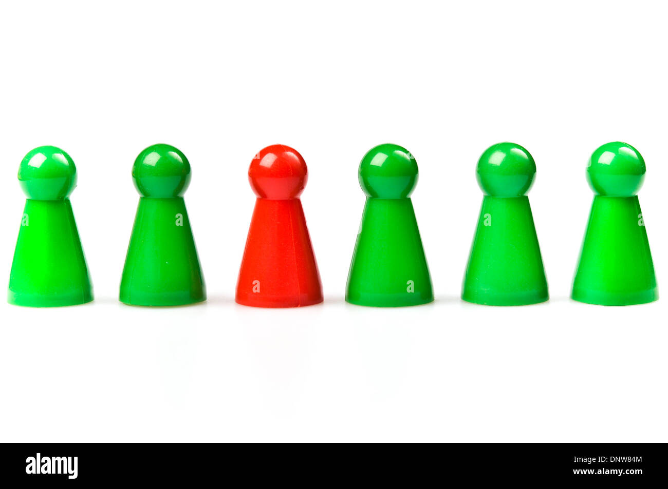 green plastic counters with one red, standing out concept Stock Photo
