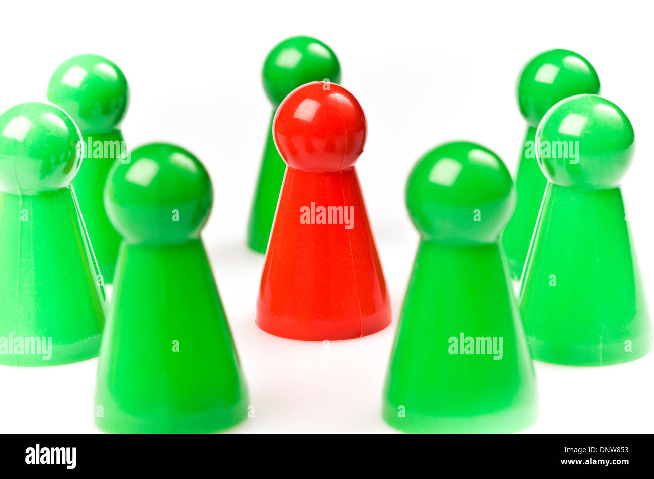 green plastic counters around one red, teamwork concept Stock Photo