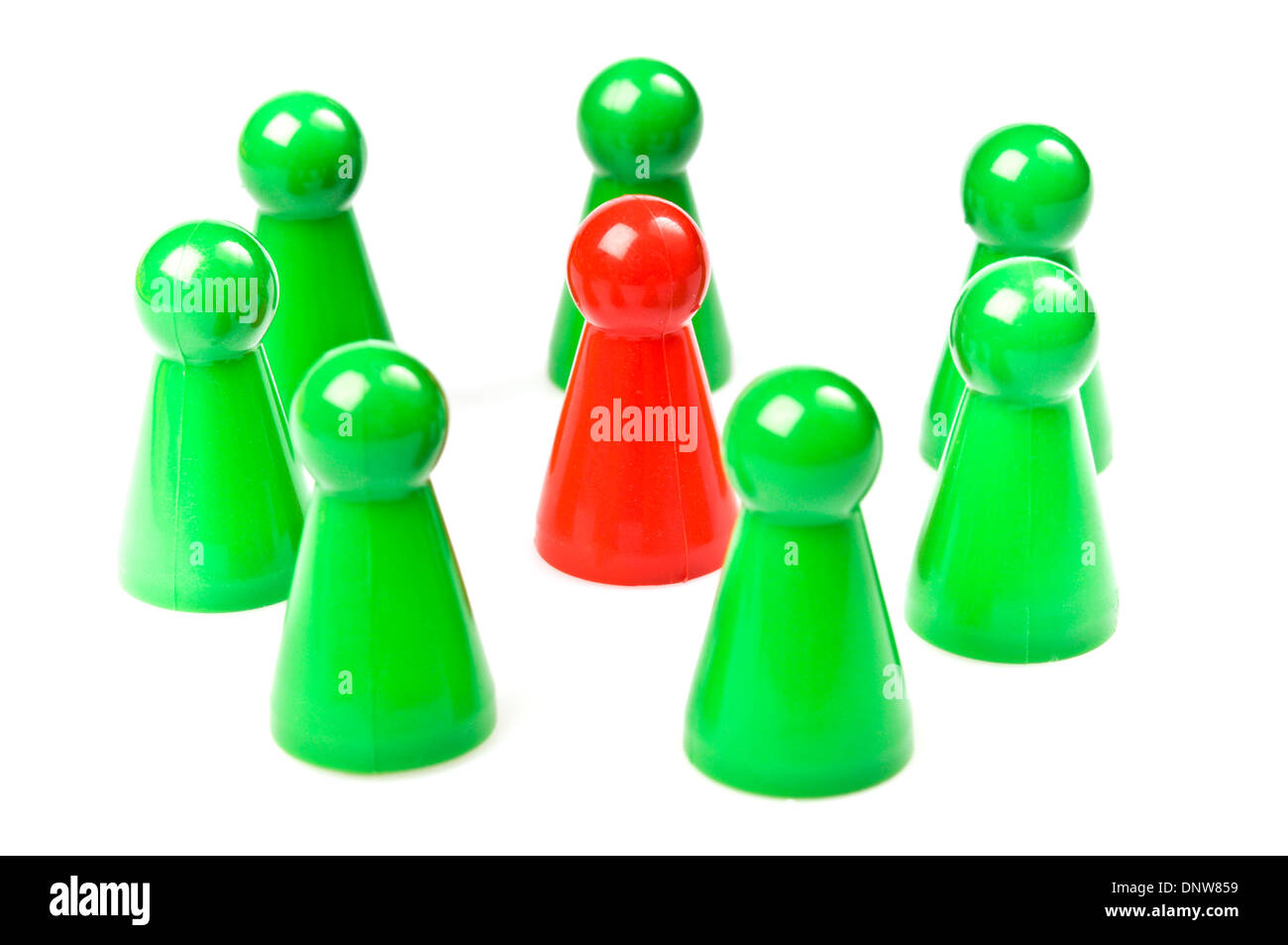 green plastic counters around one red, teamwork concept Stock Photo