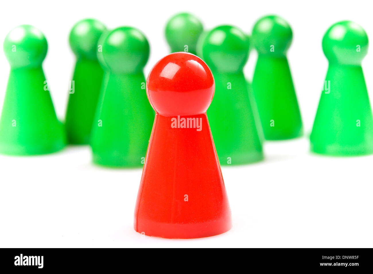 green plastic counters with one red, leadership concept Stock Photo