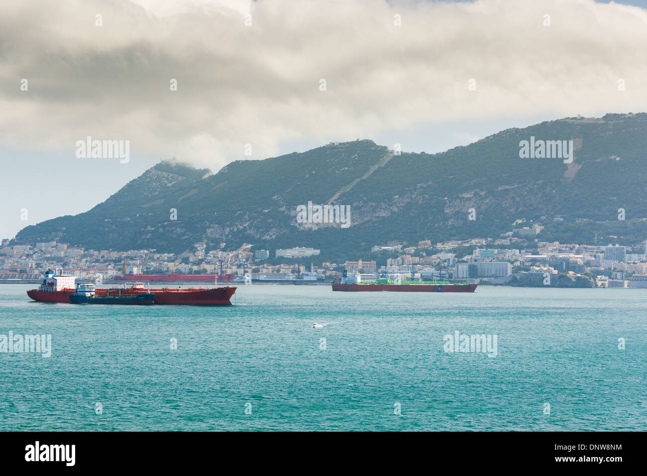 Tankers and cargo ships at anchor off Gibraltar, refueling from small