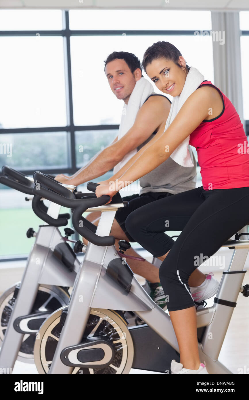 Young woman and man working out at spinning class Stock Photo - Alamy