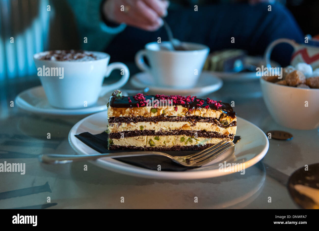 Chocolate and Pistachio nut cake afternoon tea and coffee with candle light Stock Photo