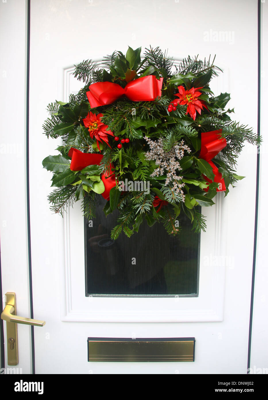Christmas holly wreath on uPVC front door Stock Photo - Alamy
