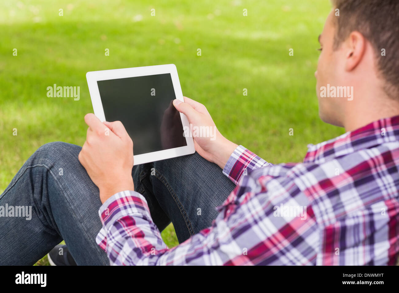 Happy student using his tablet outside Stock Photo