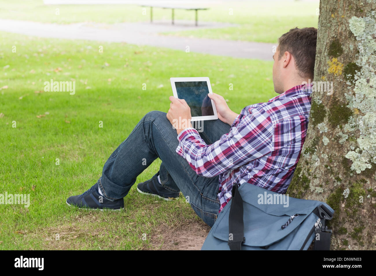 Student using his tablet pc outside Stock Photo