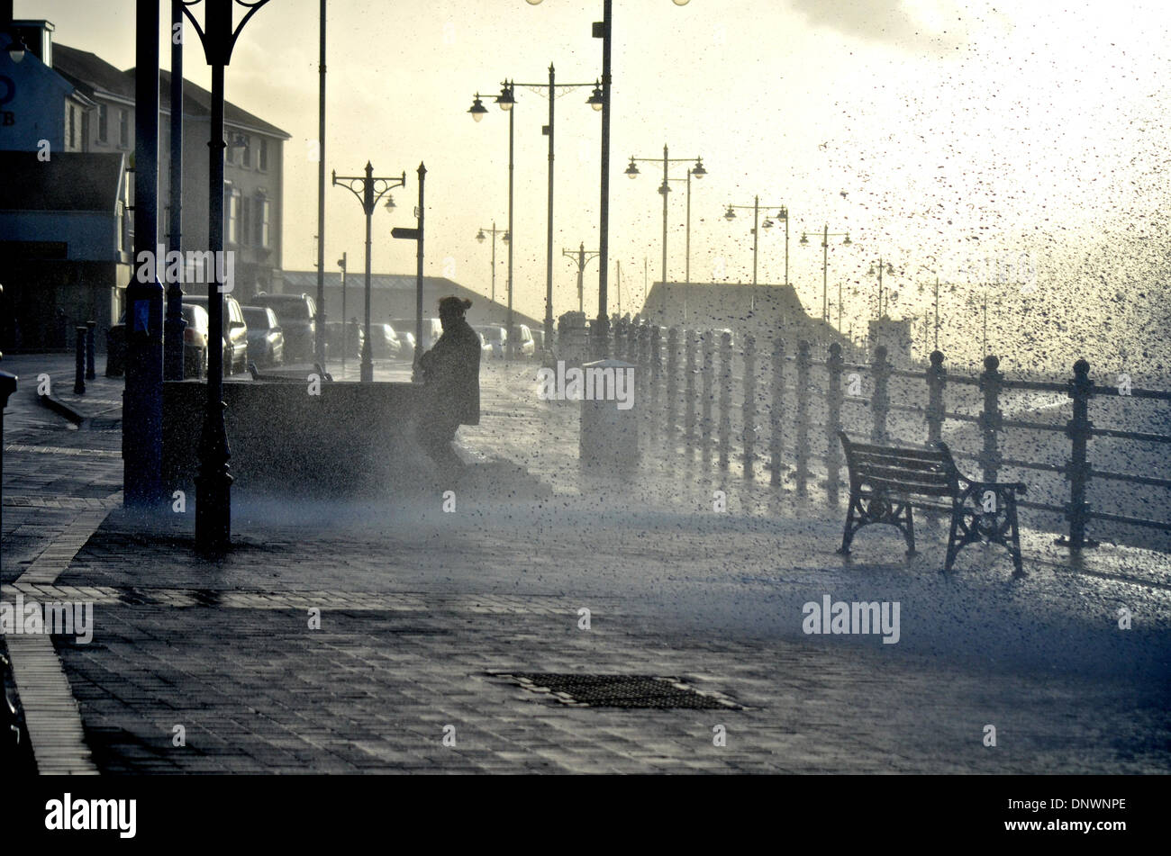 Porthcawl, Wales, UK. 06th Jan, 2014. A woman is soaked as high tides and stron winds batter the coastline at Porthcawl, Wales, UK. Credit:  Tom Guy/Alamy Live News Stock Photo