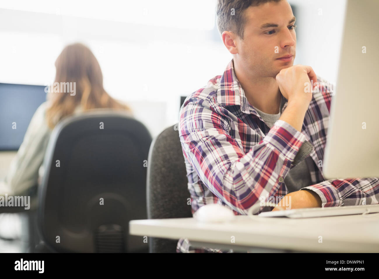 Focused student working in the computer room Stock Photo
