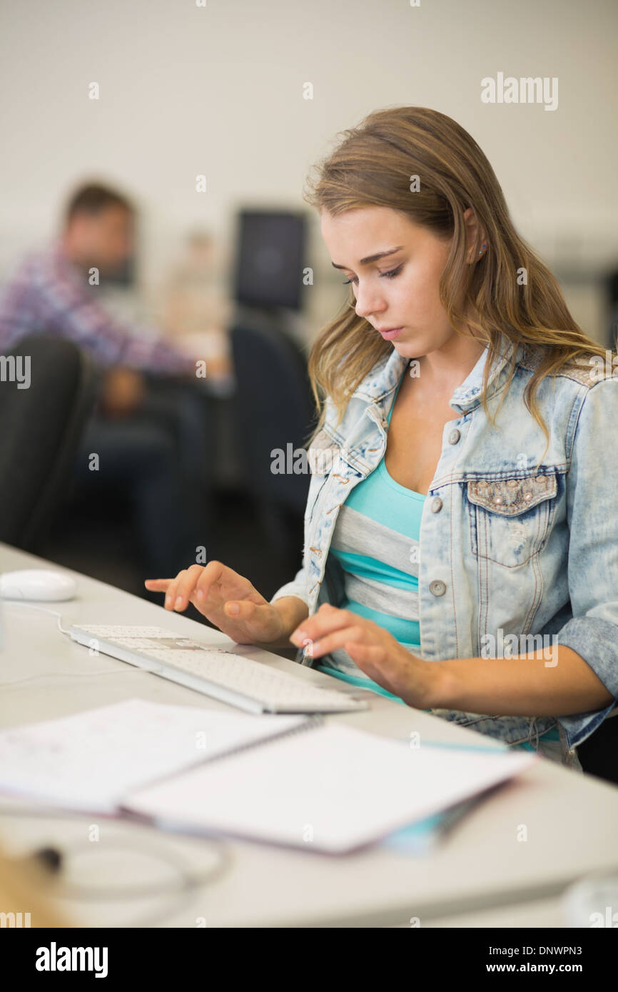 Focused pretty student working in the computer room Stock Photo