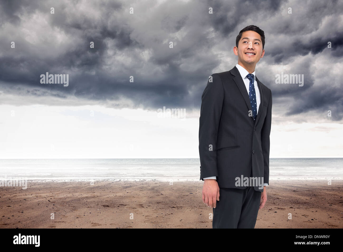 Composite image of smiling asian businessman pointing Stock Photo - Alamy