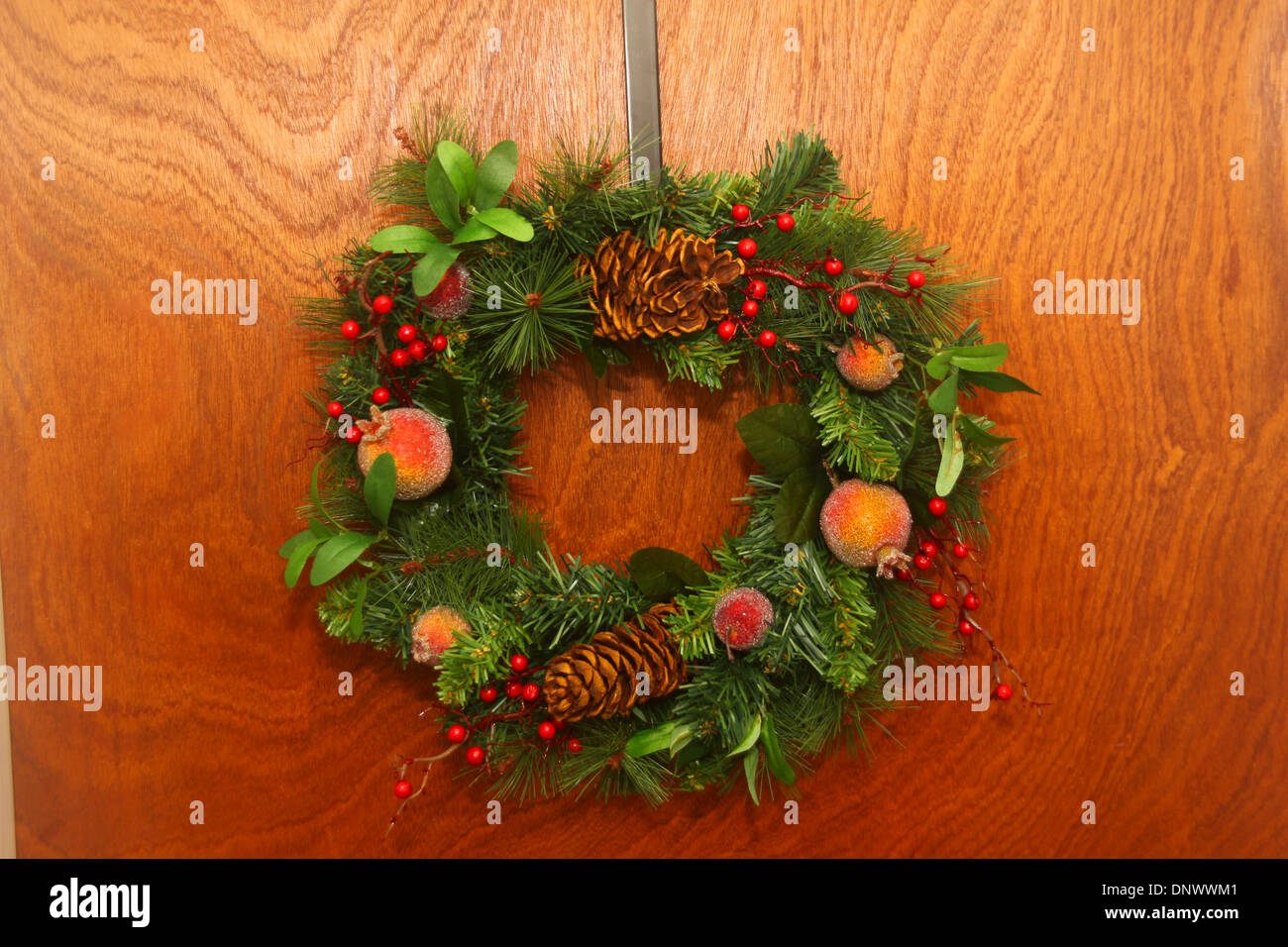 Decorative holly wreath on inside wooden door Stock Photo - Alamy