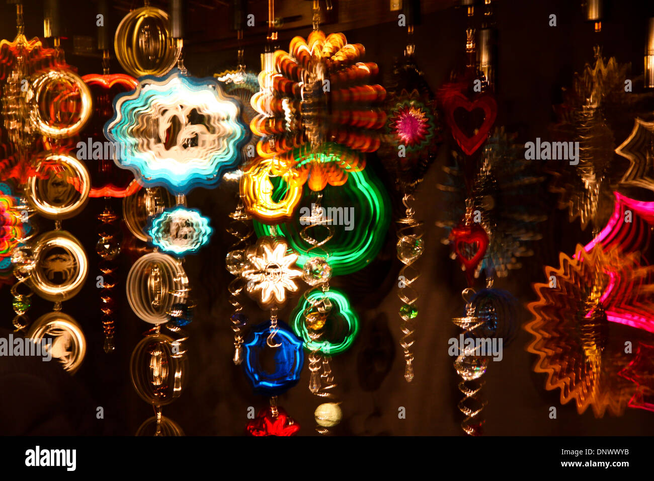 Colourful mobiles hanging on display in market stall Stock Photo