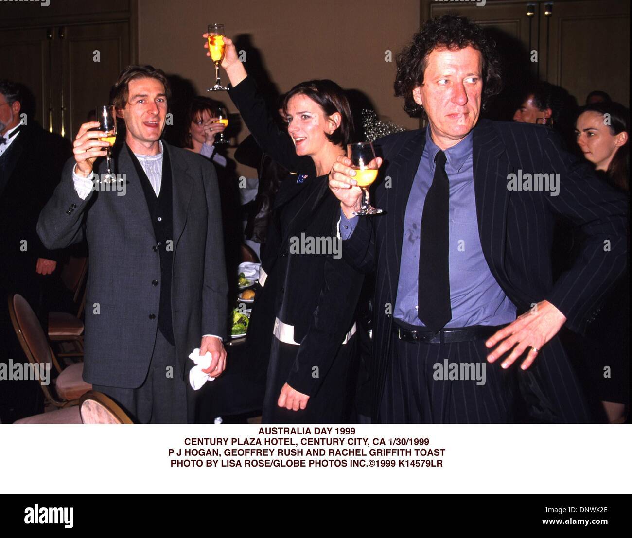 Jan. 30, 1999 - K14579LR      01/30/99.AUSTRALIA DAY 1999.CENTURY PLAZA HOTEL, CENTURY CITY, CA..P J HOGAN, GEOFFREY RUSH AND RACHEL GRIFFITH TOAST. LISA ROSE/   1999(Credit Image: © Globe Photos/ZUMAPRESS.com) Stock Photo