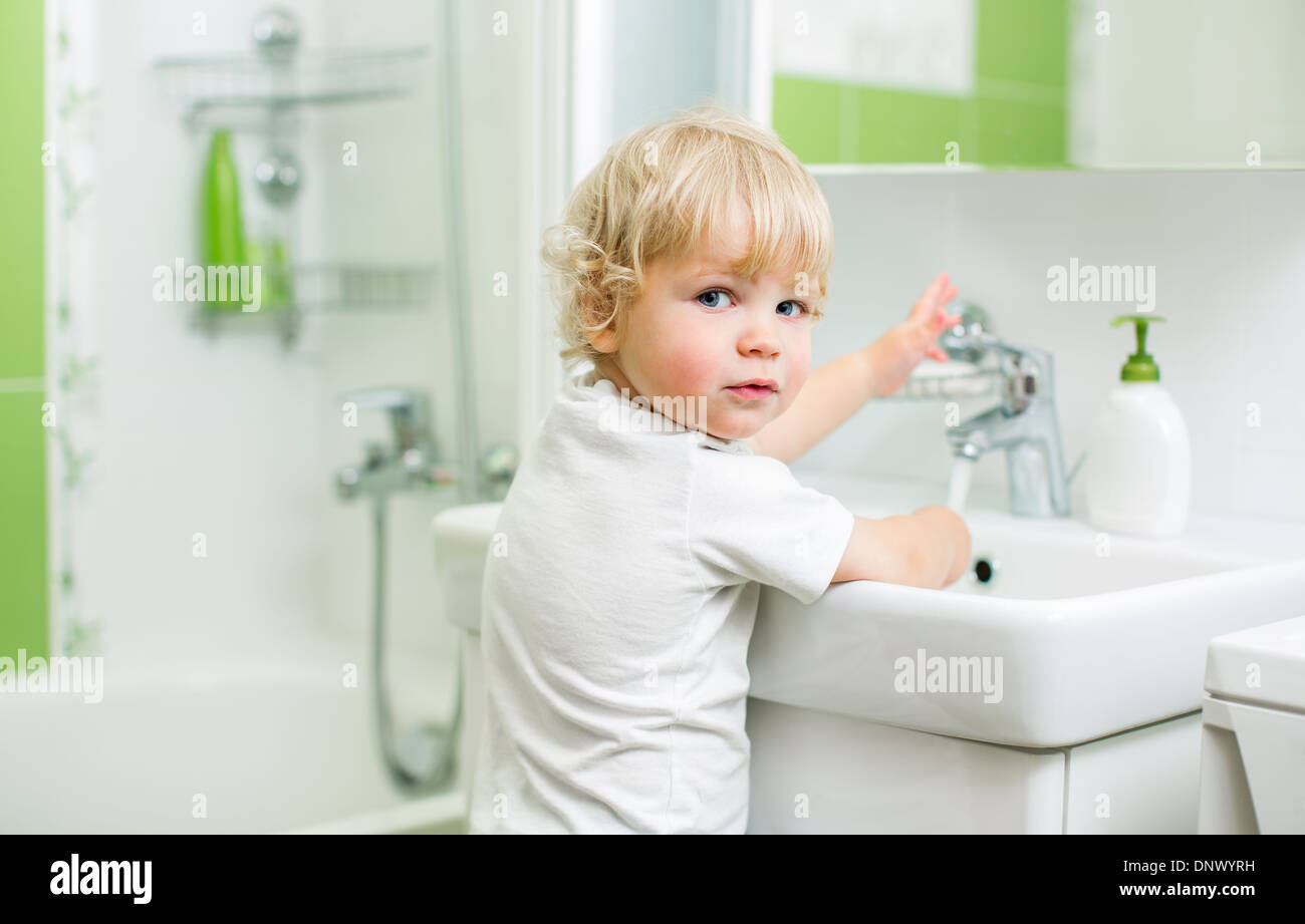 kid washing hands in bathroom Stock Photo