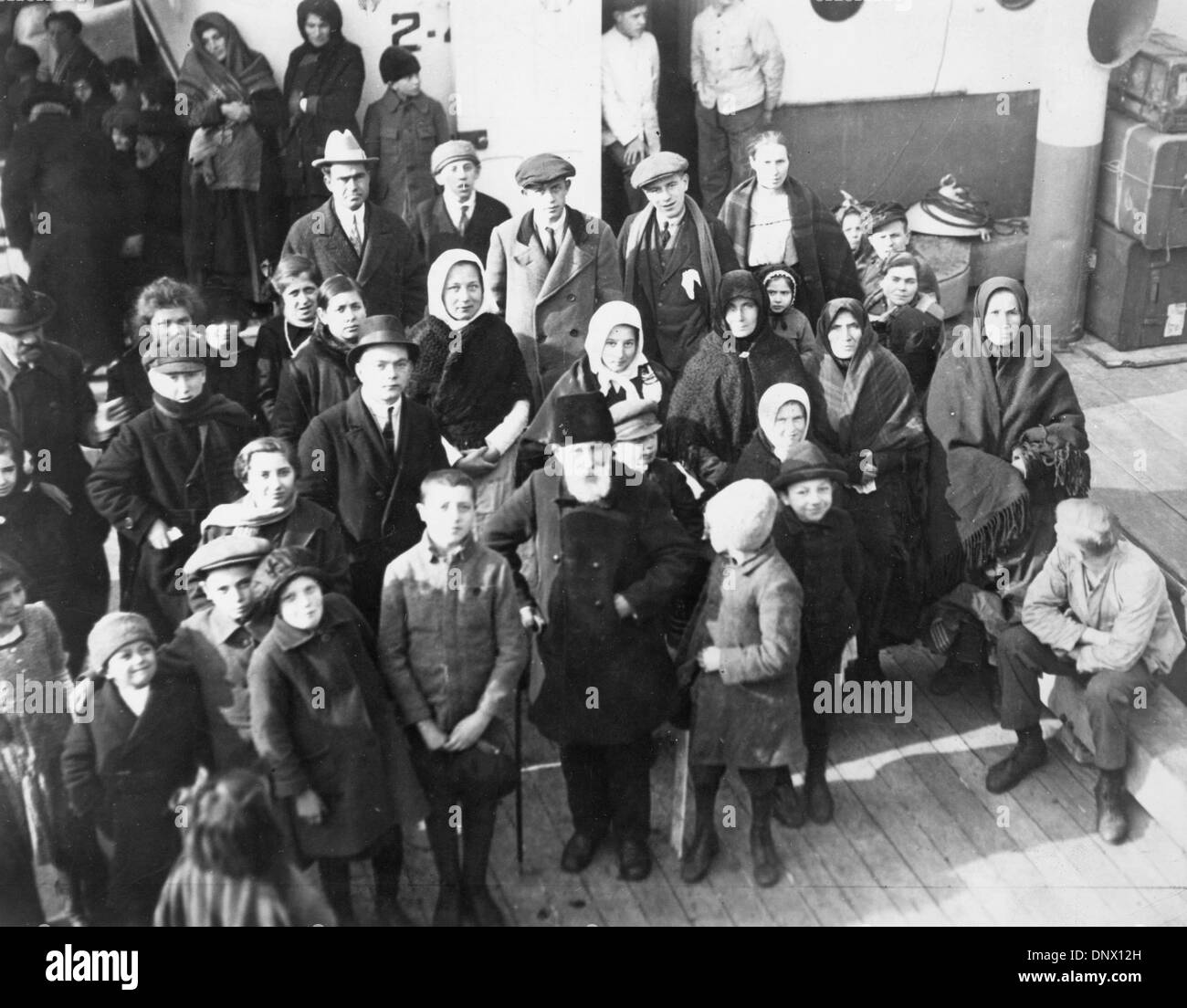 June 20, 1924 - New York, NY, U.S. - Immigrants eagerly waiting admission into the United States. A unique race is on between a dozen liners and authorities are preparing for the busy day when they arrive. The steamers, carrying hundreds of immigrants are racing from Ambrose Light to Quarantine New York, and the first vessels arriving will be examined first. The reason for this hur Stock Photo