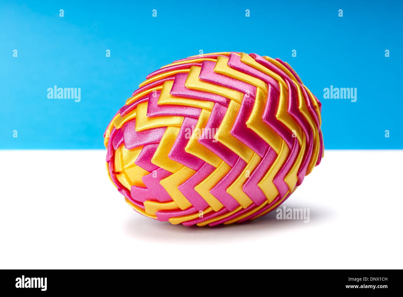 Beautiful colorful easter egg on blue and white background Stock Photo ...