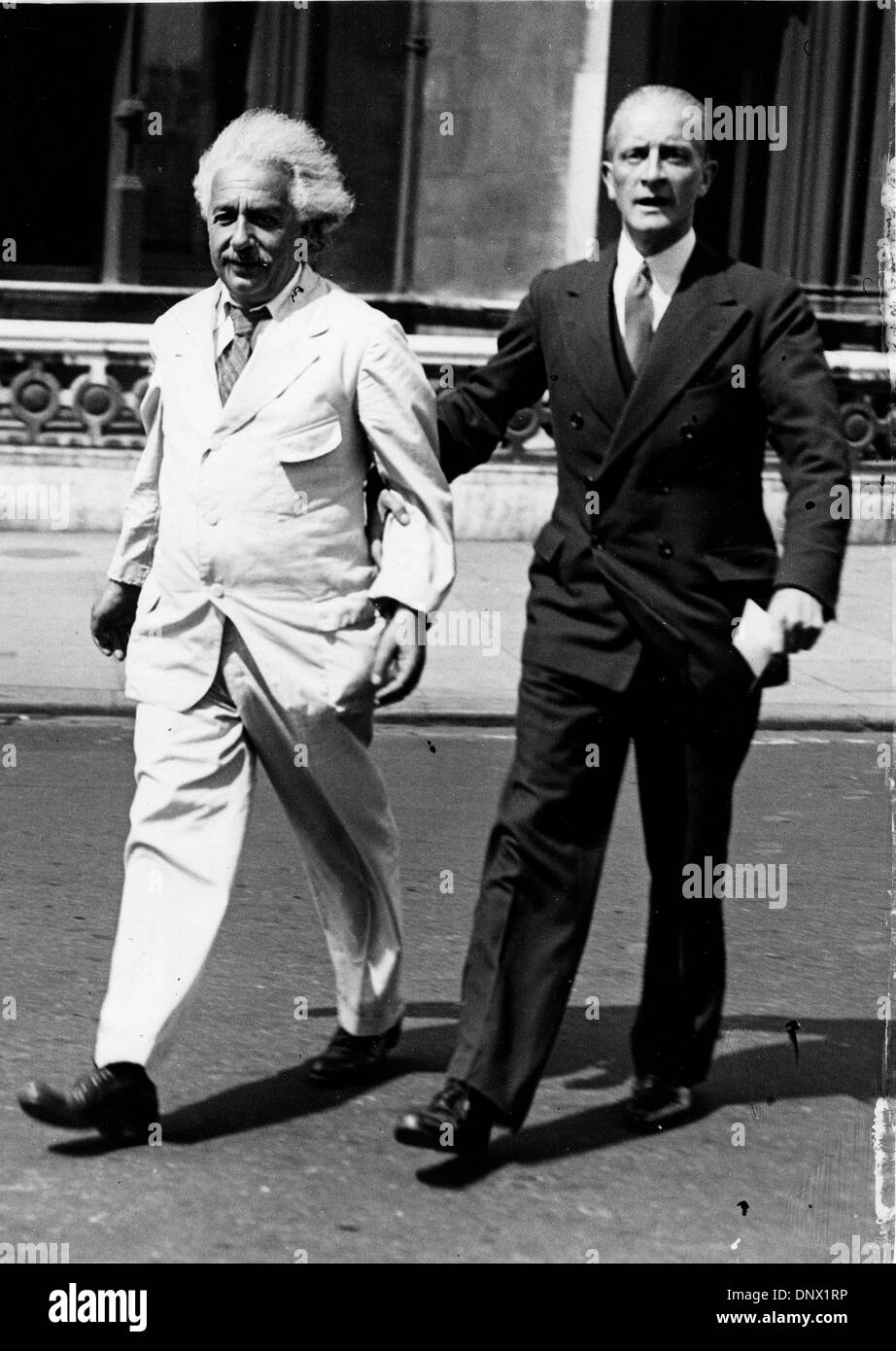 July 26, 1933 - London, England, U.K. - Professor ALBERT EINSTEIN walking with Commander LOCKER LAMPSON. Einstein (March 14, 1879 Ð April 18, 1955) was a German theoretical physicist regarded as the greatest scientist of the 20th century. He proposed the theory of relativity and made contributions to the development of quantum mechanics, statistical mechanics, and cosmology. (Credi Stock Photo