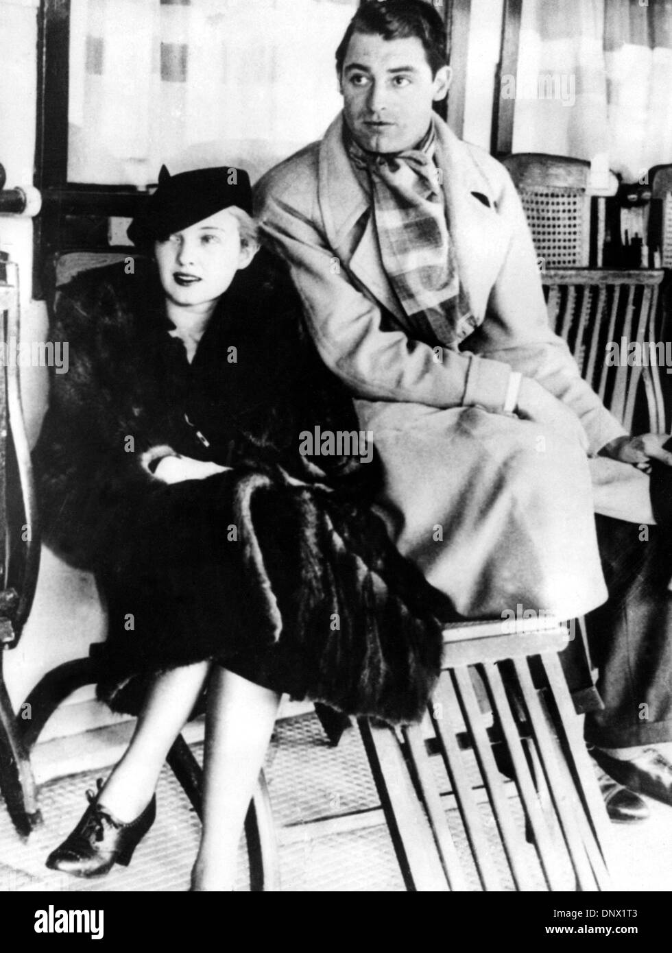 Nov. 23, 1933 - Los Angeles, CA, U.S. - British-born actor CARY GRANT (born Archibald Leach) with his future wife VIRGINIA CHERRILL before leaving to England. Grant escaped his humble Bristol environs and unstable home life by joining an acrobatic troupe, where he became a stilt-walker. Numerous odd jobs kept him going until he tried acting, and, after moving to the United States,  Stock Photo