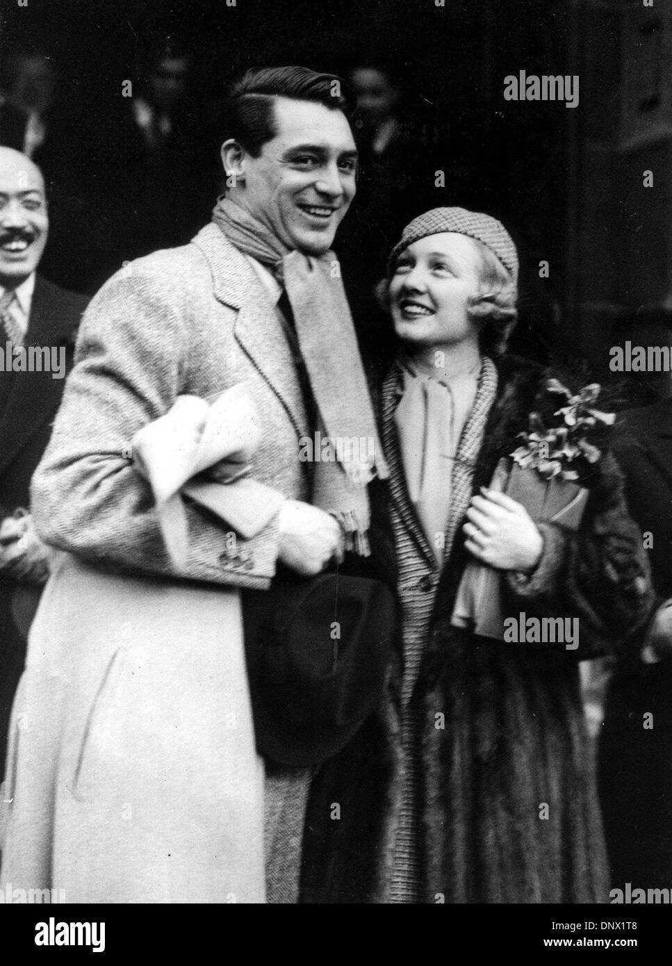 Feb. 9, 1934 - London, England, U.K. - British-born actor CARY GRANT (born Archibald Leach) with VIRGINIA CHERRILL after their wedding in London. Grant escaped his humble Bristol environs and unstable home life by joining an acrobatic troupe, where he became a stilt-walker. Numerous odd jobs kept him going until he tried acting, and, after moving to the United States, he managed to Stock Photo