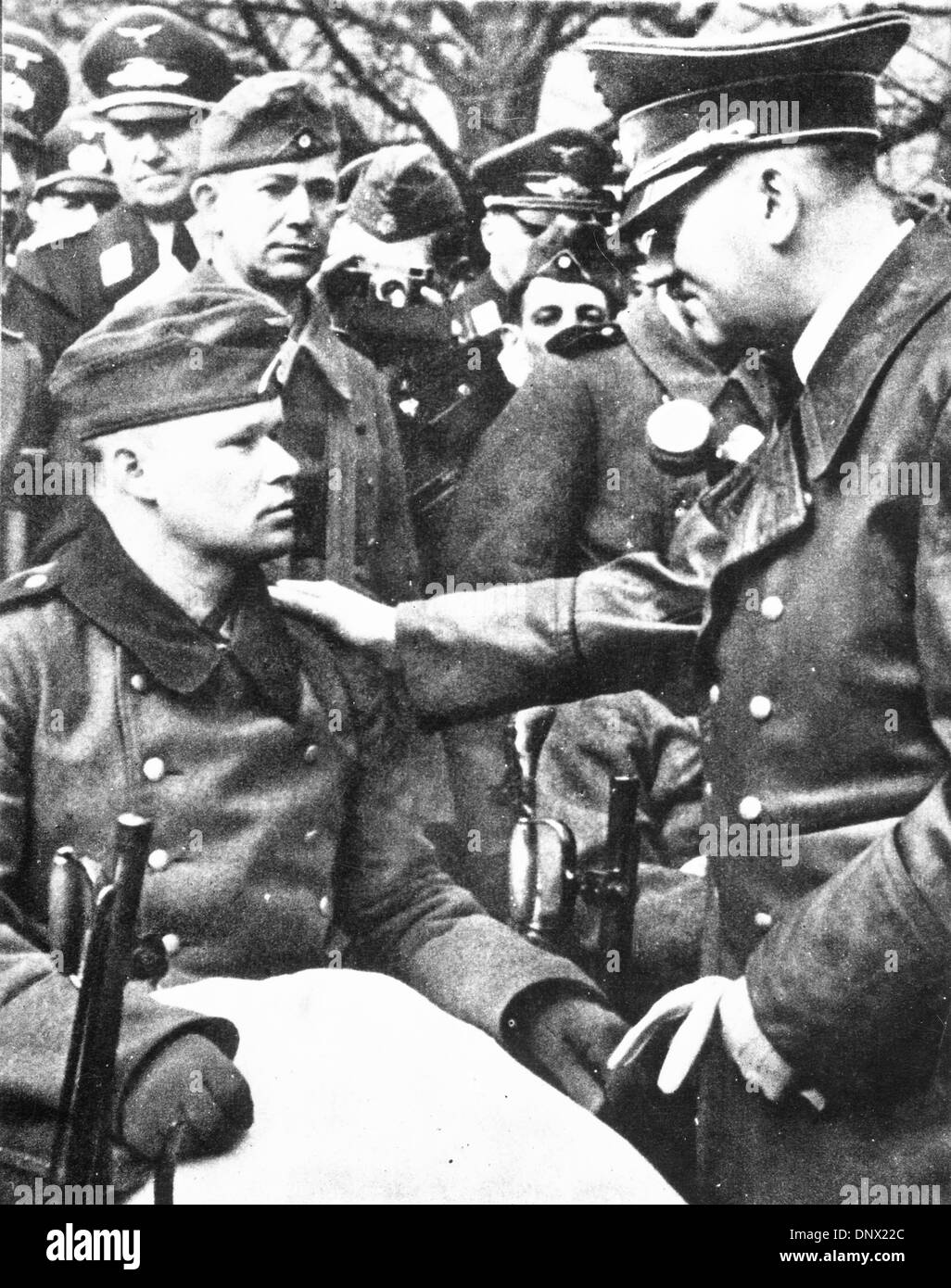 Oct. 7, 1939 - Berlin, Germany - ADOLF HITLER talks to a wounded Nazi. Adolf Hitler (April 20, 1889-April 30, 1945) was the Fuhrer und Reichskanzler (Leader and Imperial chancellor) of Germany from 1933 to his death. He was leader of the National Socialist German Workers Party (NSDAP), better known as the Nazi Party. The racial policies that Hitler directed culminated in a massive  Stock Photo