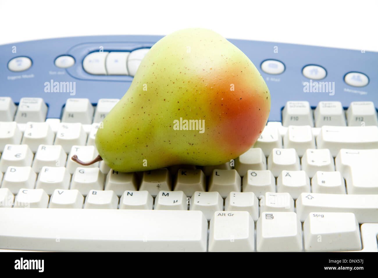 Pear with keyboard Stock Photo - Alamy