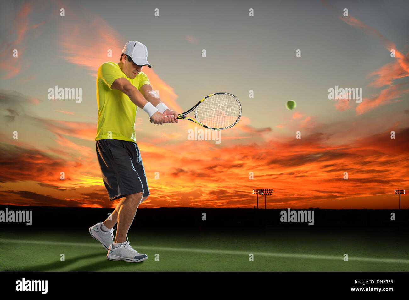 Hispanic tennis player hitting ball during sunset Stock Photo Alamy
