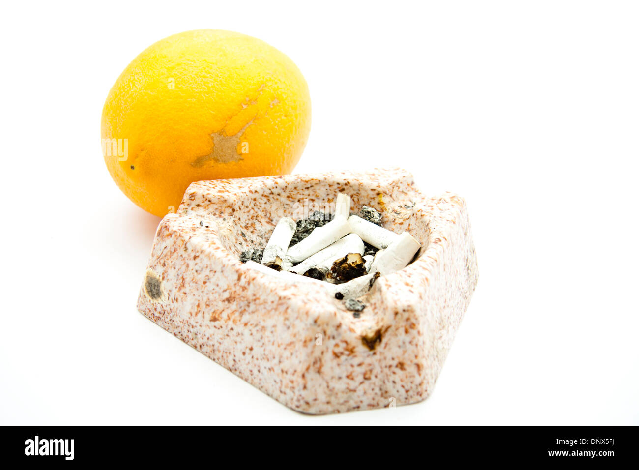 Full ashtray with orange Stock Photo Alamy