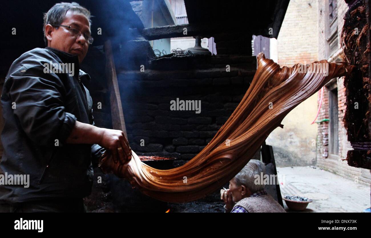 Kathmandu, Nepal. 6th Jan, 2014. A local prepares molasses (Chaku in