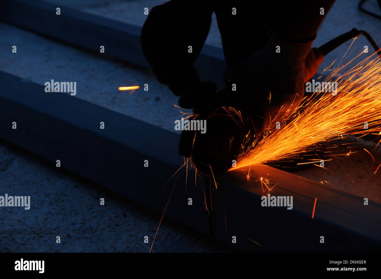 Cutting metal with grinder. Stock Photo