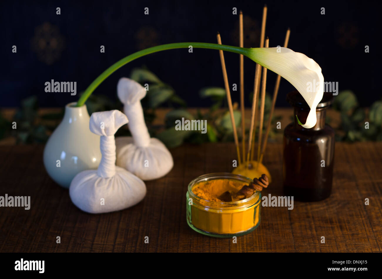 A table top arrangement of spice, oil and massaging tools, used in