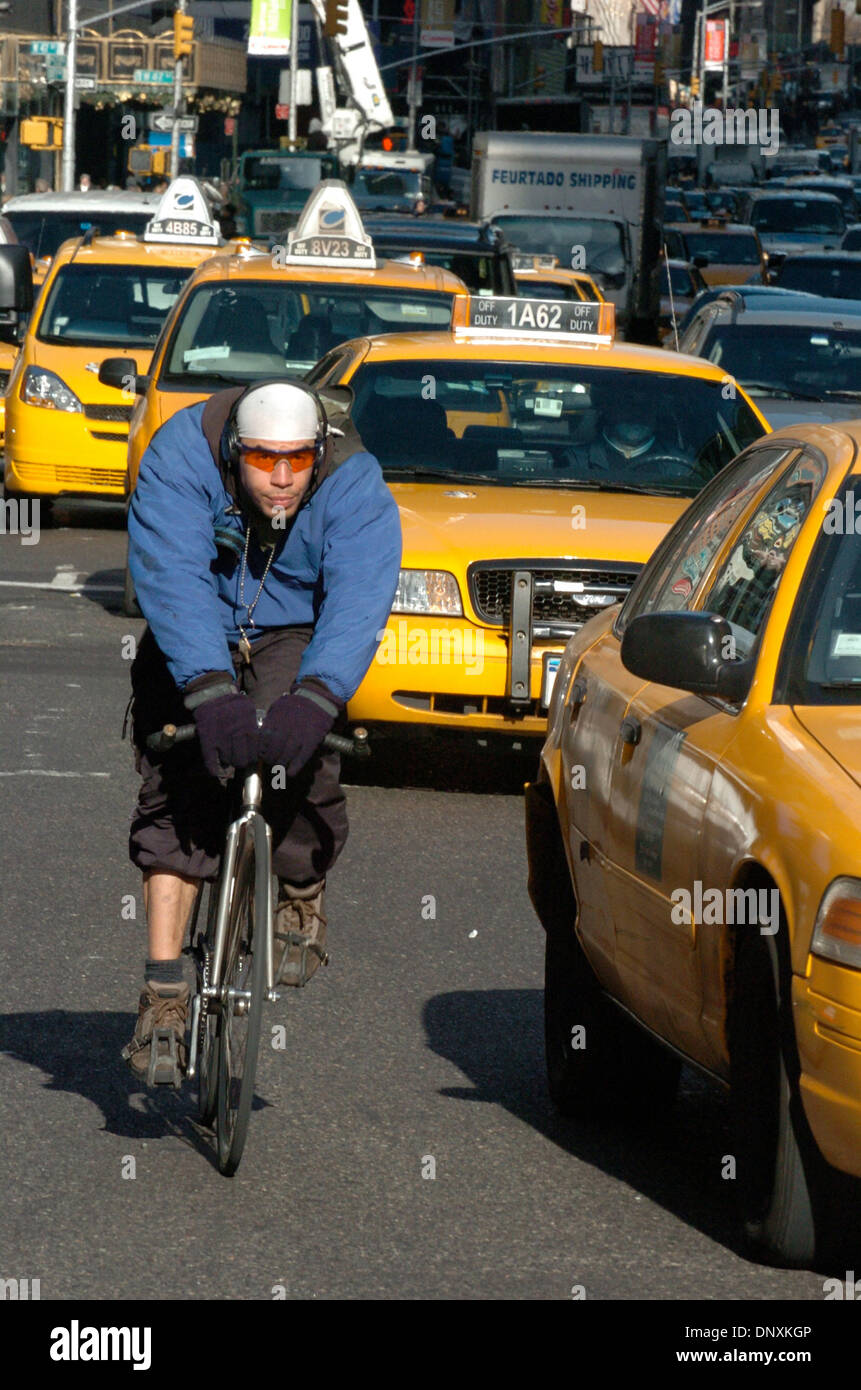 Dec 20, 2005; Manhattan, New York, USA; A bike messenger snakes through Times Square as the NYC transit workers have staged a walkout crippling transportation and affecting 7 million daily riders. The Transport Workers Union Local 100 led by President Roger Toussaint went on strike earlier this morning after contract negotiations with the Metropolitan Transportation Authority faile Stock Photo