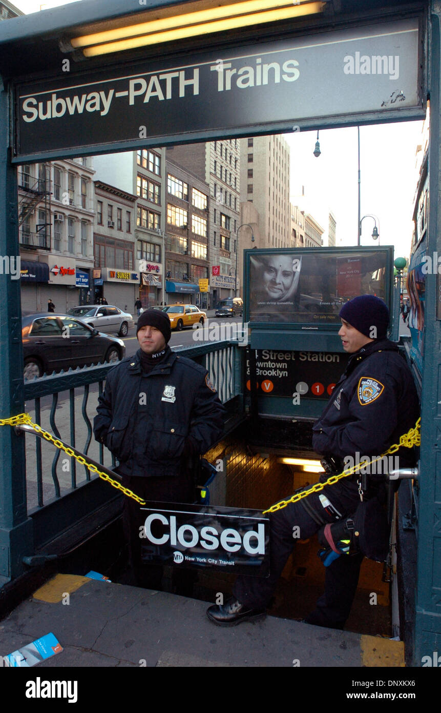 Dec 21, 2005; Manhattan, New York, USA; Police Officers NORIEGA (L) and NIEVES (R) stand at the closed entrance to the 14th Street and 6th Avenue subway station on the second day of the strike. Unable to reach an agreement with the Metropolitan Transportation Authority, NYC's 33,000 transit workers represented by Transport Workers Union Local 100 President Roger Toussaint walked of Stock Photo