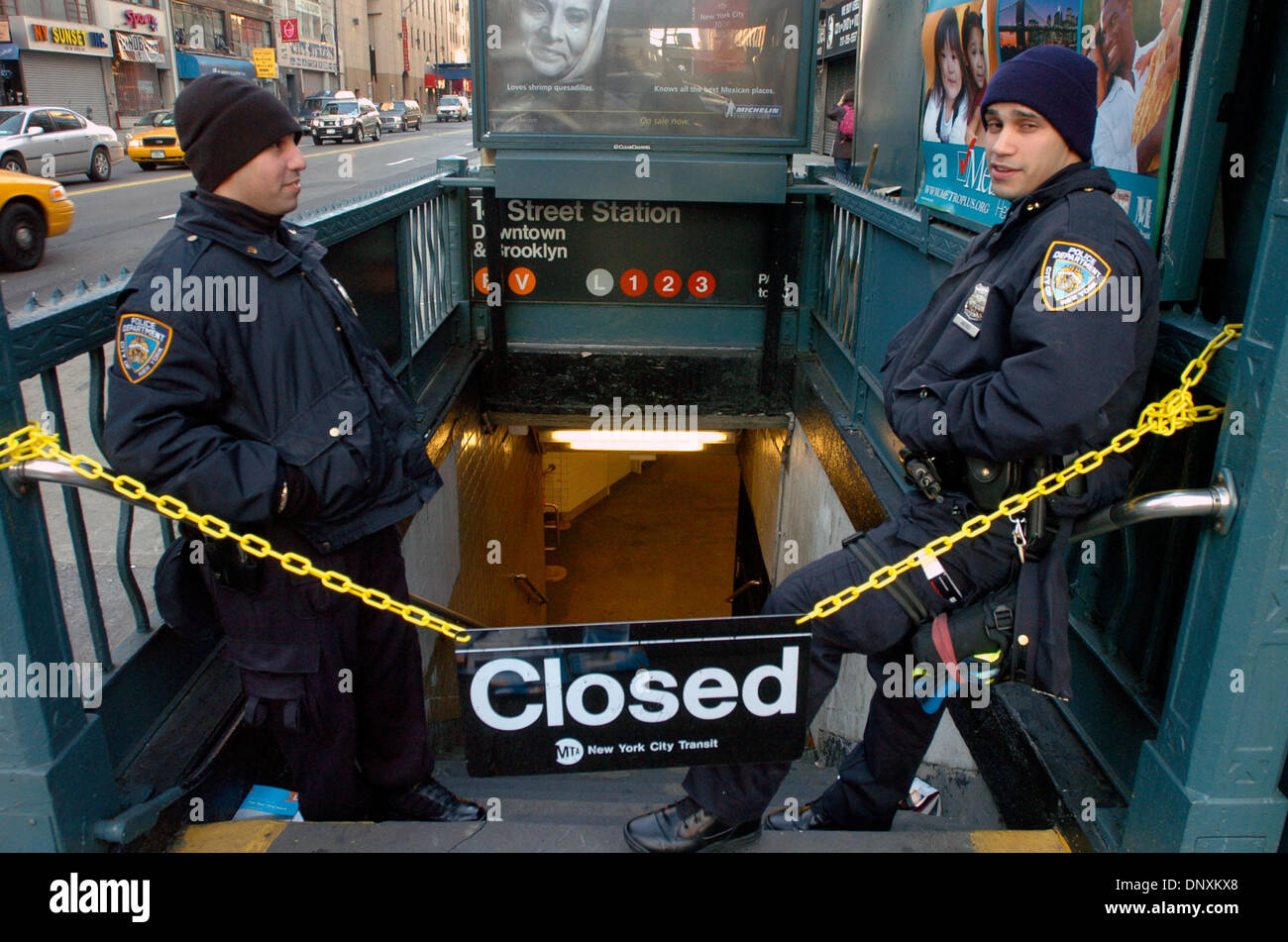 Dec 21, 2005; Manhattan, New York, USA; Police Officers NORIEGA (L) and NIEVES (R) stand at the closed entrance to the 14th Street and 6th Avenue subway station on the second day of the strike. Unable to reach an agreement with the Metropolitan Transportation Authority, NYC's 33,000 transit workers represented by Transport Workers Union Local 100 President Roger Toussaint walked of Stock Photo