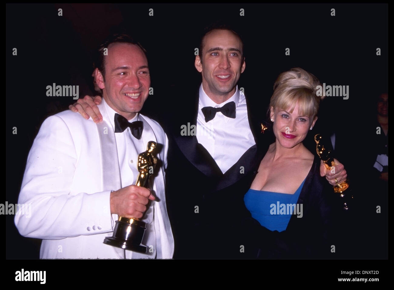 March 25, 1996.  NICOLAS CAGE with his Best Actor Oscar for 'Leaving Las Vegas,' KEVIN SPACEY with his Best Supporting Actor for 'The Usual Suspects, ' and PATRICIA ARQUETTE attend the Vanity Fair Oscar party held at Morton's.   Mandatory Credit: Kathy Hutchins/ZUMA Press. (©) Kathy Hutchins Stock Photo