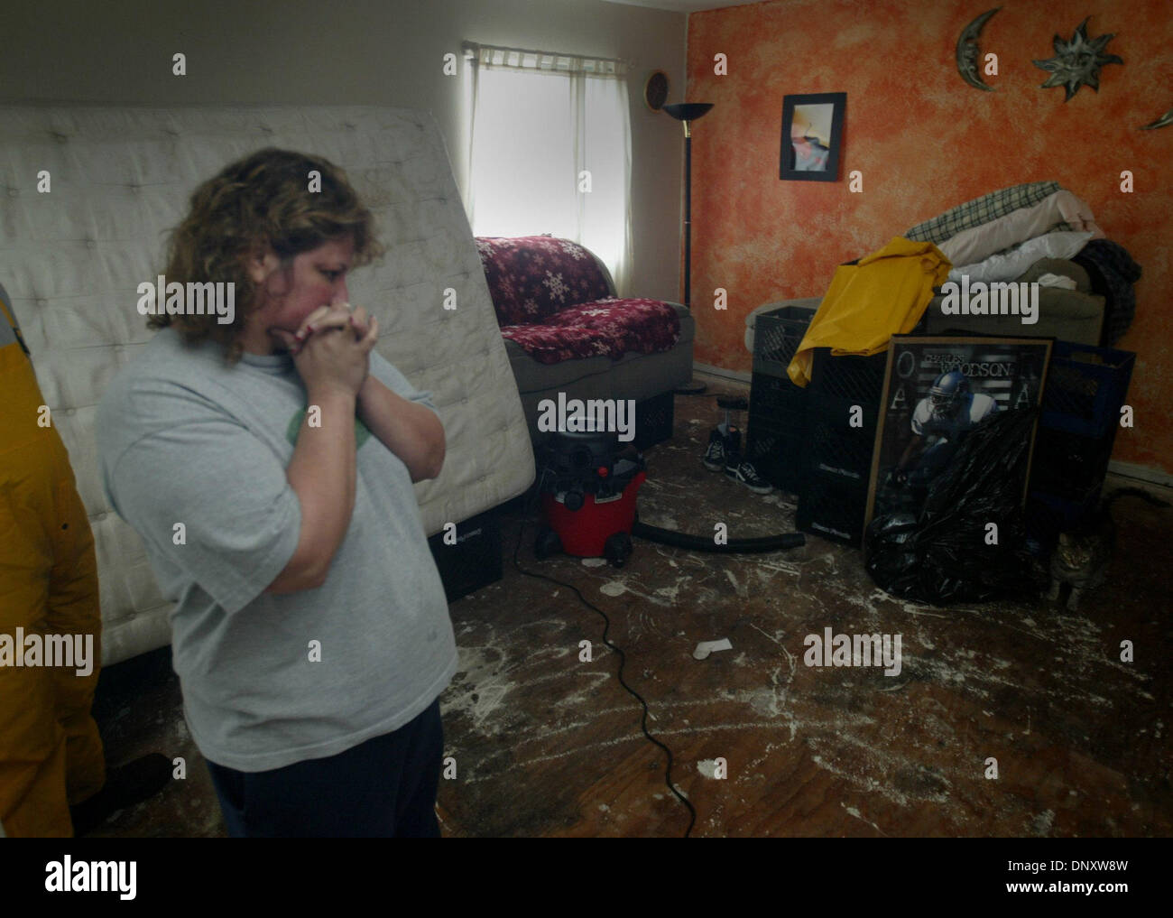 Jan 02, 2006; Napa, CA, USA; After several days of torrential rain and high winds, roads in Northern California reach saturation point and extensive flooding occurs throughout the region. Michelle Juarez stand inside her flooded rented home off lincoln Ave. in Napa.  Mandatory Credit: Photo by Bryan Patrick/Sacramento Bee/ZUMA Press. (©) Copyright 2006 by Sacramento Bee Stock Photo
