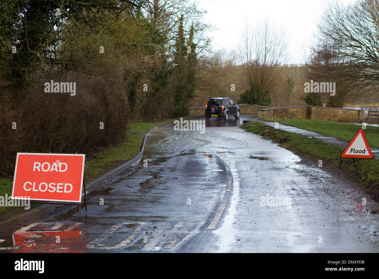 Car going throw a flood Road closed Due to Flooding Stock Photo - Alamy