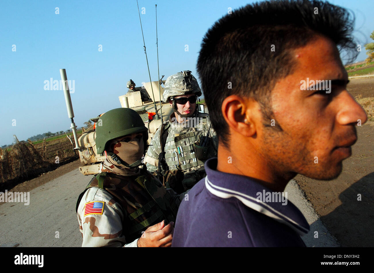 Jan 14, 2006; Abu Ghraib, Baghdad, IRAQ; An American Army interpreter asks an Iraqi man about his job with 1st Lt. KURT MCNALLY during a traffic stop on a country road north of Abu Ghraib, Iraq, Jan. 14, 2006. The man said he was a taxi driver in Baghdad. McNally is a platoon leader in Co. A, 2nd of the 22nd Infantry, 10th Mountain Division. Mandatory Credit: Photo by Bill Putnam/Z Stock Photo