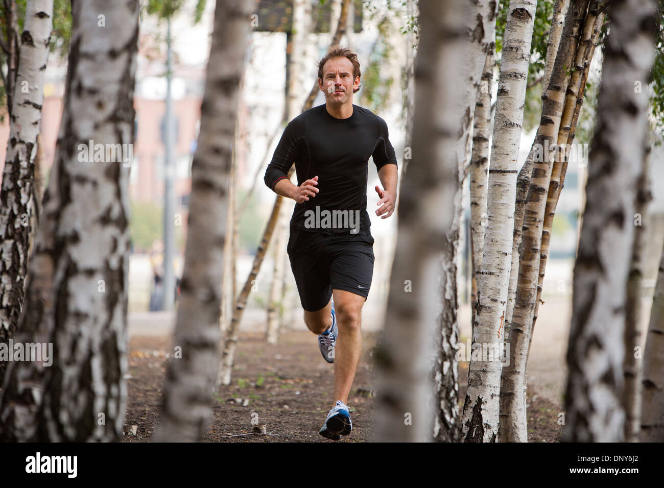 Gary Hicking, personal trainer in London, UK, keeping fit by jogging through the city. Stock Photo