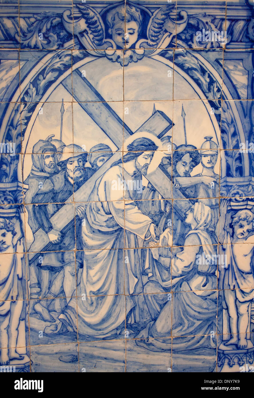 Portuguese azulejos painted tiles painting of Christ carrying the cross Igreja de Sao Francisco church Évora Alentejo Portugal Stock Photo