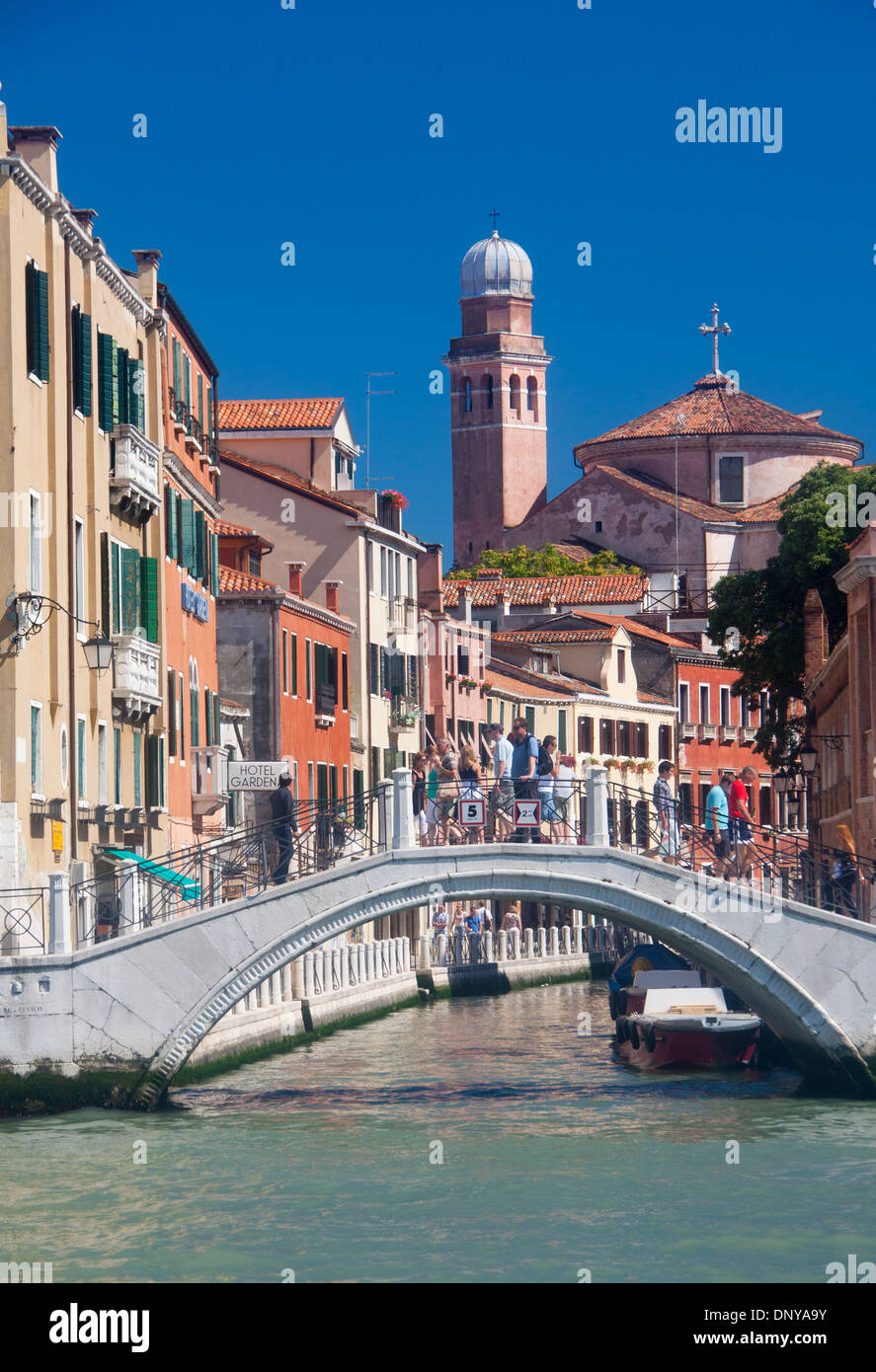 San Nicolo da Tolentino church with canal and people tourists crossing bridge Santa Croce sestier Venice Veneto Italy Stock Photo