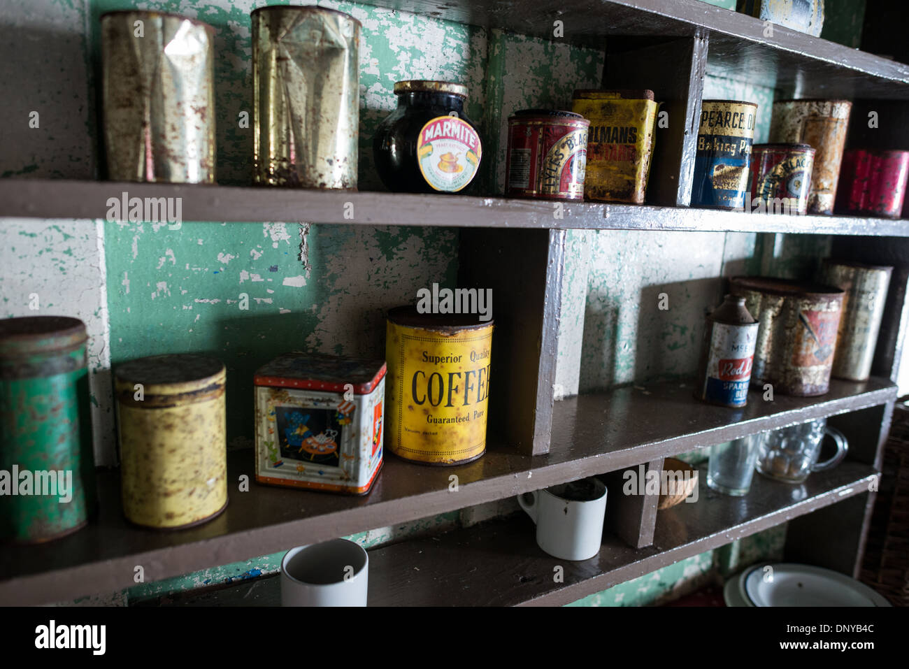 Wordie House Kitchen Food Storage Cans Winter Island Antarctica // WINTER ISLAND, Antarctica — The kitchen area of Wordie House, featuring a large radio with the acronym FIDS for Falkland Islands Dependency Survey. Originally established in 1947 as Base F by the Falkland Islands Dependencies Survey, the successor organization to Operation Tabarin, and later renamed after James Wordie, chief scientist and geologist on Ernest Shackleton's Endurance expedition, this research station is preserved near Vernadsky Research Base in the Argentine Islands. Stock Photo