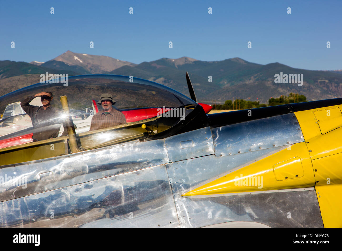 Visitors viewed through canopy of a Van's Aircraft RV4; Antique and modern airplanes at the annual Salida ArtWalk Fly-In event Stock Photo